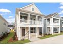 Charming two-story home featuring a welcoming double porch and neutral siding at 9237 Kitchin Farms Way # 429, Wake Forest, NC 27587
