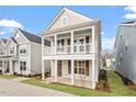 Charming two-story home featuring a welcoming double porch and neutral siding at 9237 Kitchin Farms Way # 429, Wake Forest, NC 27587