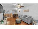 Bright and airy living room with hardwood floors, ceiling fan, and a comfortable gray sofa at 129 Sturbridge Dr # 15, Clayton, NC 27520
