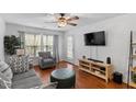 Comfortable living room with hardwood floors, plush armchair, and plenty of natural light at 129 Sturbridge Dr # 15, Clayton, NC 27520