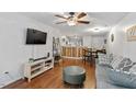 Cozy living room featuring hardwood floors, gray sofa, and bar-style seating area at 129 Sturbridge Dr # 15, Clayton, NC 27520