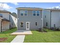 Rear exterior of house with a patio and lawn at 737 Portland Rose Dr, Knightdale, NC 27545