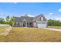 Charming single-Gathering home with a well-manicured lawn, two-car garage, and inviting curb appeal at 167 Thistle Ct, Sanford, NC 27332