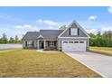 Lovely home exterior with a two-car garage, inviting front yard, and tasteful exterior accents at 167 Thistle Ct, Sanford, NC 27332
