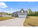Beautiful home showcasing a spacious driveway, attached two-car garage, and manicured lawn at 167 Thistle Ct, Sanford, NC 27332