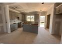 New kitchen area features modern gray cabinets, a central island, and lots of natural light at 182 Wilderness Trl, Smithfield, NC 27577