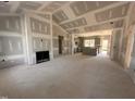 Spacious open-concept living room featuring fireplace and adjoined to kitchen with gray cabinets at 182 Wilderness Trl, Smithfield, NC 27577
