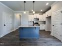 Bright kitchen with granite island, stainless steel appliances and white cabinetry at 20 S Mistflower St, Clayton, NC 27520