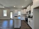 Spacious kitchen features white cabinets, stainless steel appliances, and a center island perfect for entertaining at 232 Bluejay St, Clayton, NC 27520