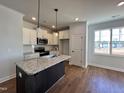 Modern kitchen with granite island and stainless steel appliances at 32 S Mistflower St, Clayton, NC 27520