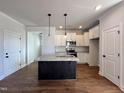 Modern kitchen with granite island and stainless steel appliances at 32 S Mistflower St, Clayton, NC 27520