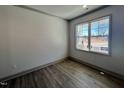 A cozy room with hardwood flooring, large windows, and fresh neutral paint at 35 S Mistflower St, Clayton, NC 27520