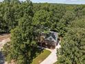 Brick house nestled among lush green trees and a curved driveway at 111 N Coslett Ct, Cary, NC 27513