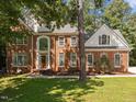 Two-story brick home with landscaped lawn and driveway at 111 N Coslett Ct, Cary, NC 27513