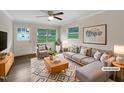 Bright living room featuring stylish furniture, ceiling fan, and plenty of natural light at 225 W Orange St, Hillsborough, NC 27278