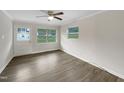 Clean and bright living room features new flooring, freshly painted walls, and a ceiling fan at 225 W Orange St, Hillsborough, NC 27278