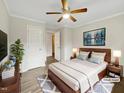 Serene main bedroom with modern furniture, ceiling fan, and soft, natural lighting at 225 W Orange St, Hillsborough, NC 27278