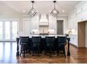 Bright kitchen with a large center island, pendant lighting, and a suite of stainless steel appliances at 123 Cottage Way, Pittsboro, NC 27312