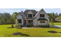 Beautifully landscaped two-story home showcasing modern farmhouse architecture at 30 Spanish Oak Dr, Youngsville, NC 27596
