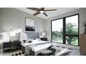 Bright main bedroom with a large window overlooking the outside, ceiling fan, and contemporary decor at 512 Gordon St # 1102, Durham, NC 27701
