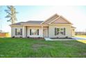 Newly constructed home with light green vinyl siding, and a two-car garage at 404 S Eastwood Dr, Benson, NC 27504