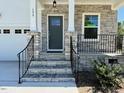 Close up view of the covered front porch with stone accents and an 