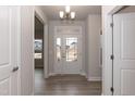 Bright entryway with hardwood floors and a white front door at 499 Glenkirk Pl # 101, Garner, NC 27529