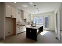 Bright kitchen with a large island, stainless appliances, white cabinets and subway tile backsplash at 704 Chatham View Rd # 12, Cary, NC 27511