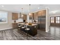 Spacious kitchen featuring an island with bar seating, stainless steel appliances, and pendant lighting at 1129 Brookfield Dr, Gibsonville, NC 27249