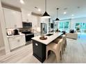 This open kitchen features a large island with seating, stainless appliances, and seamless transition to living area at 2117 Opulent Oaks Ln # 15, Durham, NC 27713
