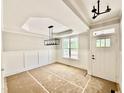 Unfinished dining room features a large window, modern light fixture, and classic wall trim at 2613 Silver Gate Ct, Wake Forest, NC 27587