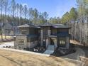 Luxury home showcasing a modern design and wooded setting at 7640 Falls Creek Ln, Raleigh, NC 27614