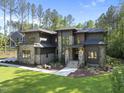 Beautiful new home with manicured lawn, stone accents, and stylish architectural design at 7640 Falls Creek Ln, Raleigh, NC 27614