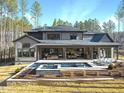 Expansive backyard oasis featuring a pool, spa, and patio at 7640 Falls Creek Ln, Raleigh, NC 27614