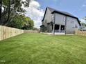 Large, level back yard with a newly installed wood fence and covered porch on the home at 627 Georgetown Rd, Raleigh, NC 27608