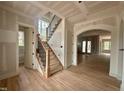 A view of the entryway with a staircase featuring wood treads and iron spindles leading to the upper level at 627 Georgetown Rd, Raleigh, NC 27608