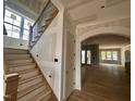 A view of the entryway with a staircase featuring wood treads and iron spindles leading to the upper level at 627 Georgetown Rd, Raleigh, NC 27608