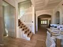 Unfinished new home interior featuring hardwood floors, a staircase, arched doorways, and large windows at 627 Georgetown Rd, Raleigh, NC 27608