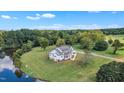 Aerial view of a stunning home with a lake, surrounded by mature trees and expansive green space at 1618 Ben Wilson Rd, Mebane, NC 27302