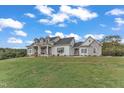 Charming two-story home with a stone and white exterior, well-manicured lawn, and a serene setting at 1618 Ben Wilson Rd, Mebane, NC 27302