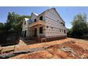 New construction two-story home showing exterior framing and brick foundation at 208 E Whitaker Mill Rd, Raleigh, NC 27608