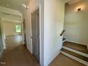Inviting foyer with wood floors, neutral walls, and staircase access at 235 Grand Griffon Way, Lillington, NC 27546