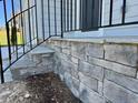 Close up of the stonework surrounding the front porch, highlighting the detail and craftsmanship at 235 Grand Griffon Way, Lillington, NC 27546