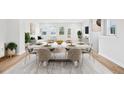 Dining area with a large table setting, bright natural light and open concept at 1170 Holding Village Way, Wake Forest, NC 27587
