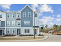 New construction townhouse with a blue color palette and clean architectural lines at 1170 Holding Village Way, Wake Forest, NC 27587