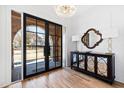 Bright entry with hardwood floors, stunning arched double doors, and elegant console table at 1610 Carson St, Raleigh, NC 27608
