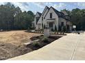 An exterior elevation shot features a white brick home under construction, a driveway, and a For Sale sign at 65 Firefly Overlook, Pittsboro, NC 27312