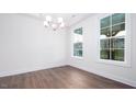 Bright dining room featuring hardwood floors and large windows that bring in lots of natural light at 1110 Jersey St, Haw River, NC 27258