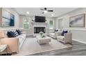 Bright living room features a fireplace, comfy seating, and hardwood floors at 116 Oak Ridge Dr, Willow Springs, NC 27592