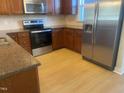 Modern kitchen features stainless steel appliances and granite countertops at 49 Danbury Ct, Pittsboro, NC 27312